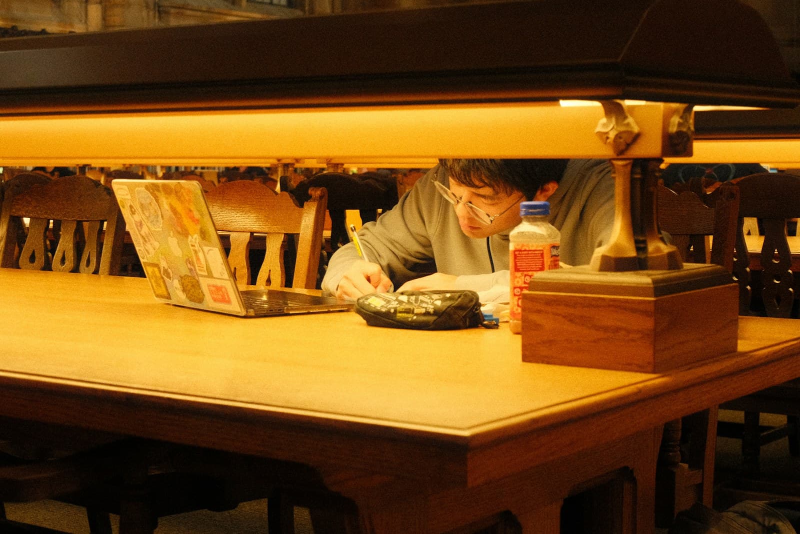 Applicant reviewing an application draft at a library table
